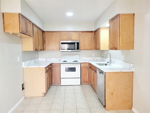 kitchen featuring sink, light tile patterned floors, and stainless steel appliances