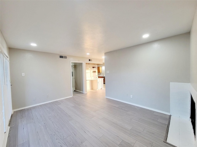 unfurnished living room featuring light hardwood / wood-style floors