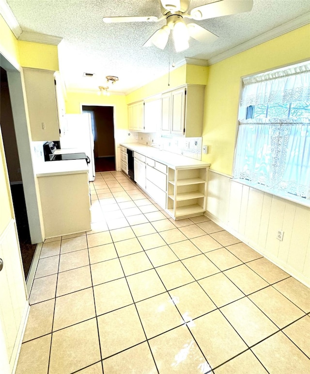 kitchen with a healthy amount of sunlight, ornamental molding, and a textured ceiling