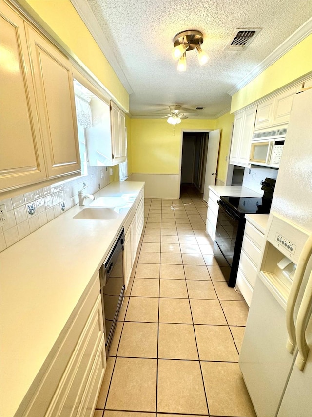 kitchen featuring light tile patterned flooring, sink, decorative backsplash, ceiling fan, and black appliances