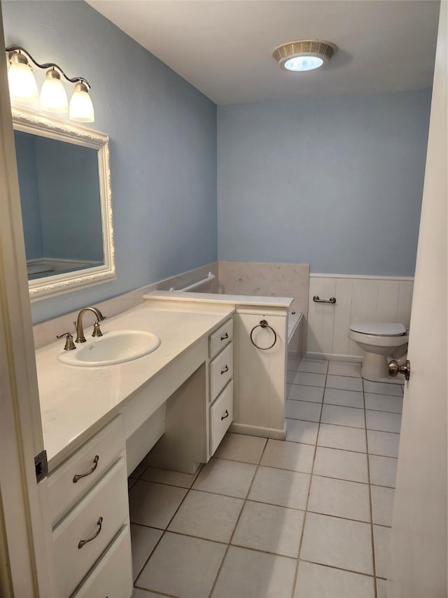 bathroom with tile patterned flooring, vanity, and toilet