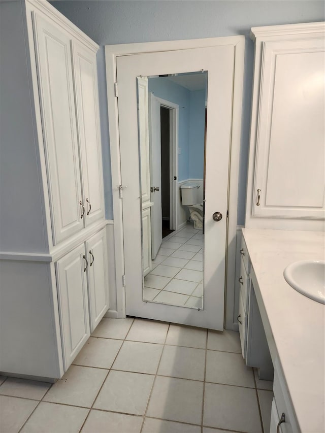 bathroom with vanity, toilet, and tile patterned flooring