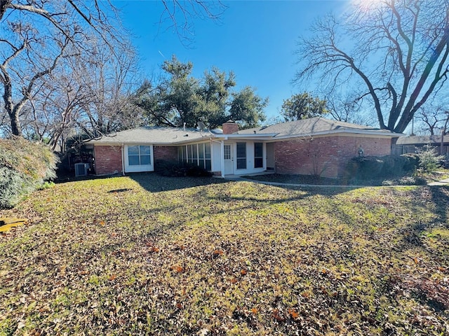 back of property featuring a yard