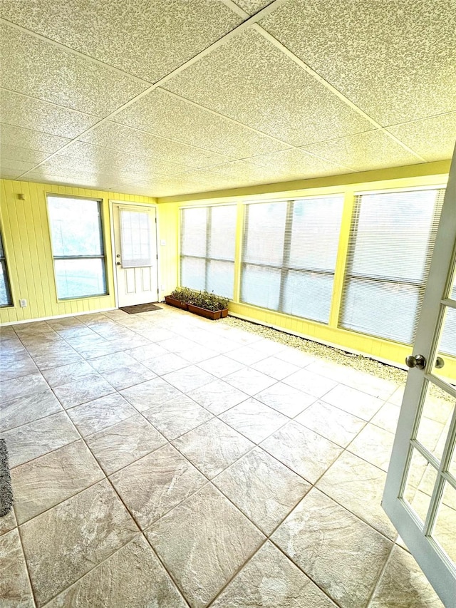 unfurnished sunroom featuring a paneled ceiling