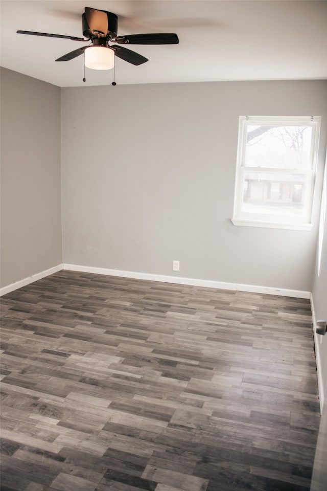 spare room with ceiling fan and dark hardwood / wood-style flooring