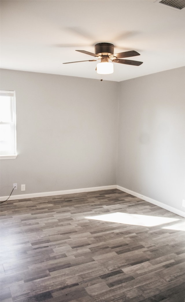 empty room featuring dark hardwood / wood-style floors and ceiling fan