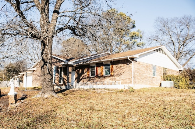 view of property exterior featuring central AC unit and a garage