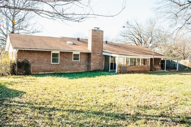 rear view of property with a yard