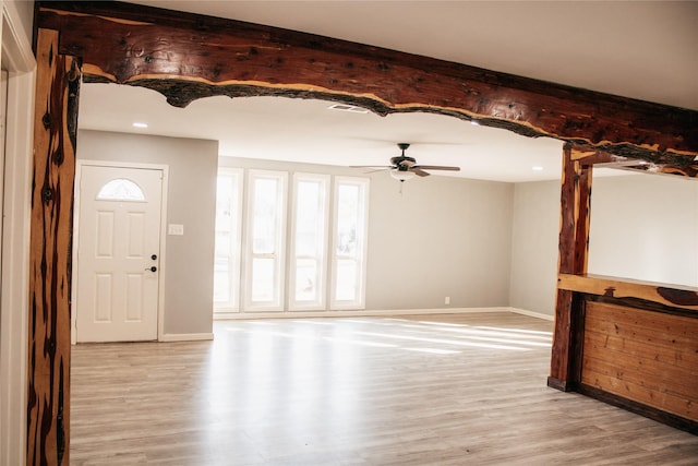 unfurnished living room with ceiling fan and light wood-type flooring