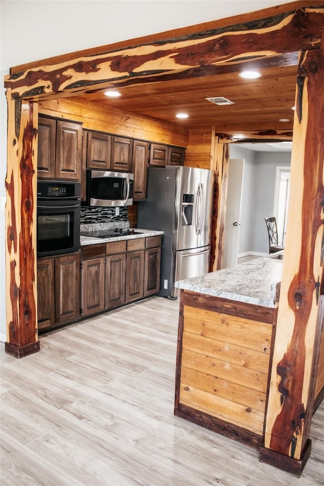 kitchen with stainless steel appliances, light hardwood / wood-style floors, and wooden ceiling