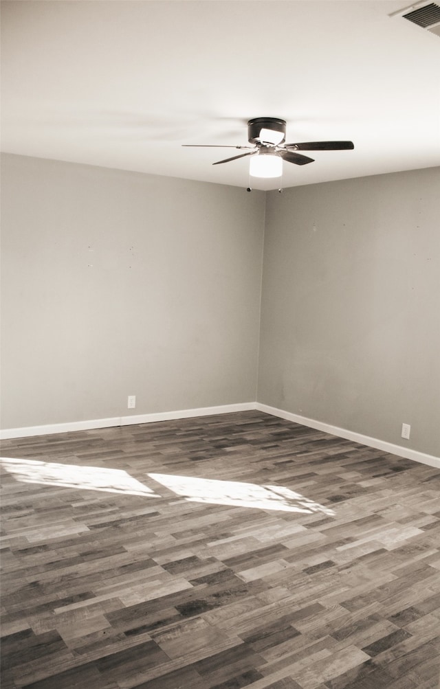 unfurnished room with ceiling fan and dark hardwood / wood-style flooring