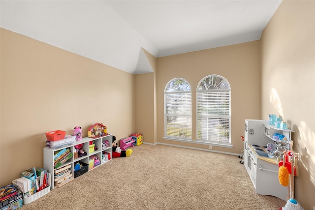 game room featuring carpet and vaulted ceiling