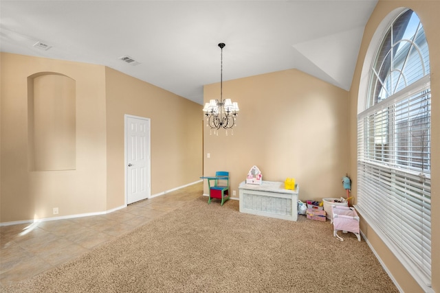 playroom featuring light carpet, vaulted ceiling, and a notable chandelier