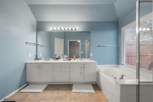 bathroom with plus walk in shower, tile patterned flooring, vanity, and lofted ceiling