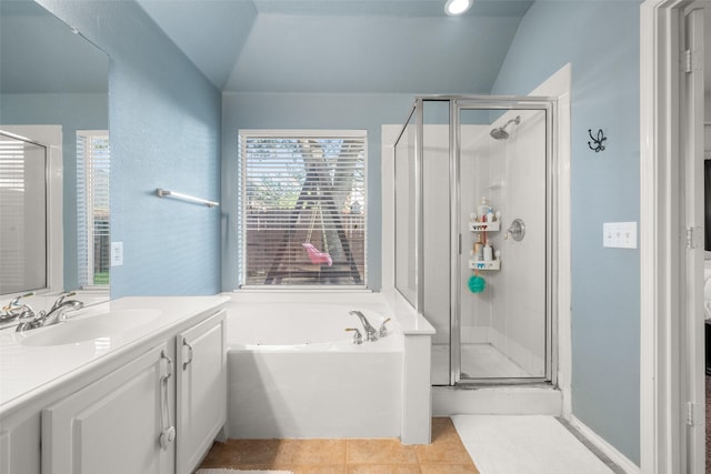 bathroom with tile patterned floors, vanity, lofted ceiling, and shower with separate bathtub