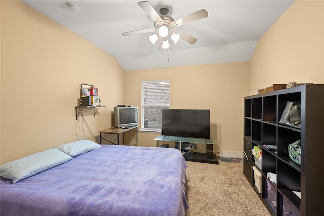 carpeted bedroom with ceiling fan and vaulted ceiling