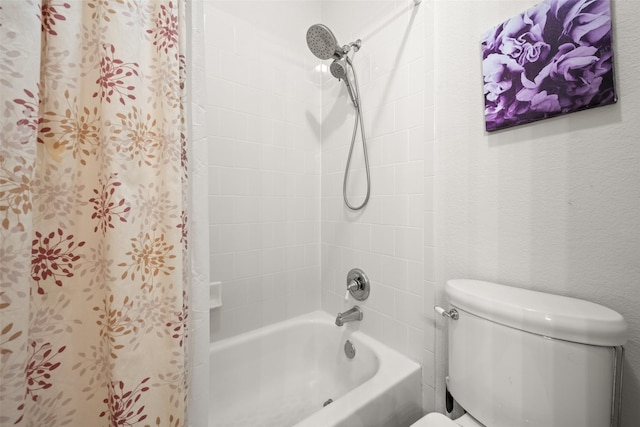 bathroom featuring toilet and tiled shower / bath