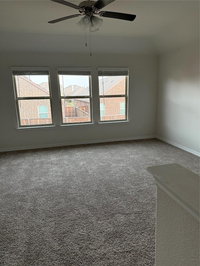 empty room with ceiling fan and carpet floors