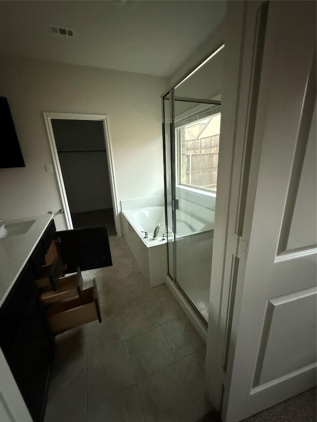 bathroom with tile patterned floors, vanity, and separate shower and tub