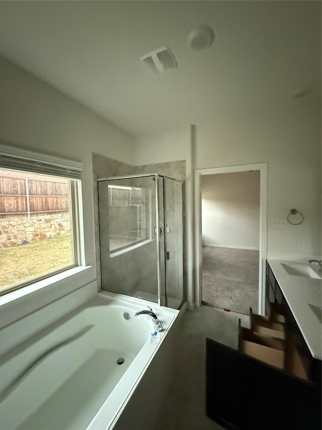 bathroom with vanity and shower with separate bathtub