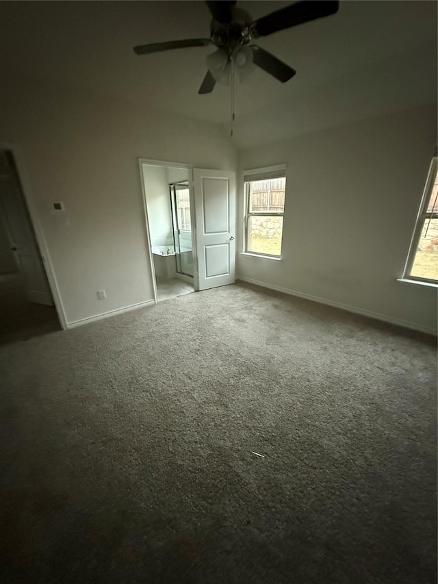 unfurnished bedroom featuring ensuite bath, ceiling fan, and carpet