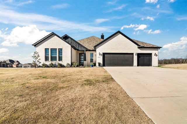 view of front facade with a garage and a front yard