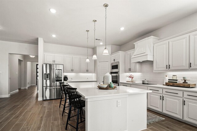 kitchen featuring appliances with stainless steel finishes, a center island, and white cabinetry