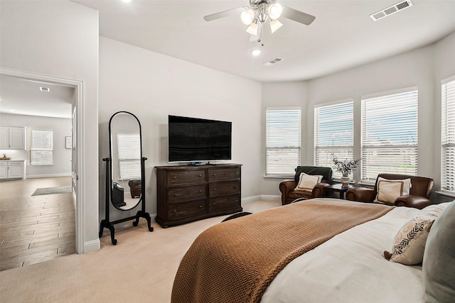 bedroom featuring ceiling fan and light carpet