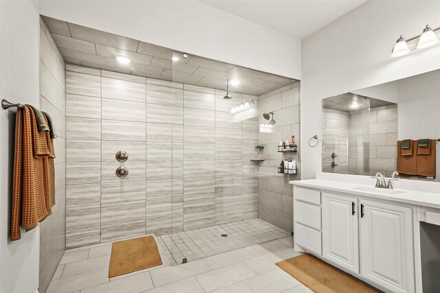 bathroom featuring tile patterned floors, vanity, and tiled shower