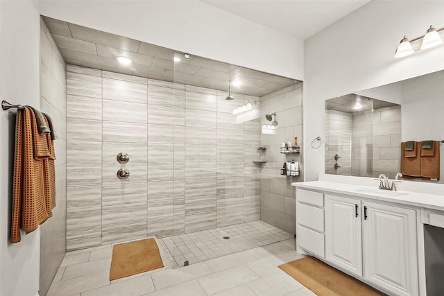 bathroom featuring vanity, tiled shower, and tile patterned floors