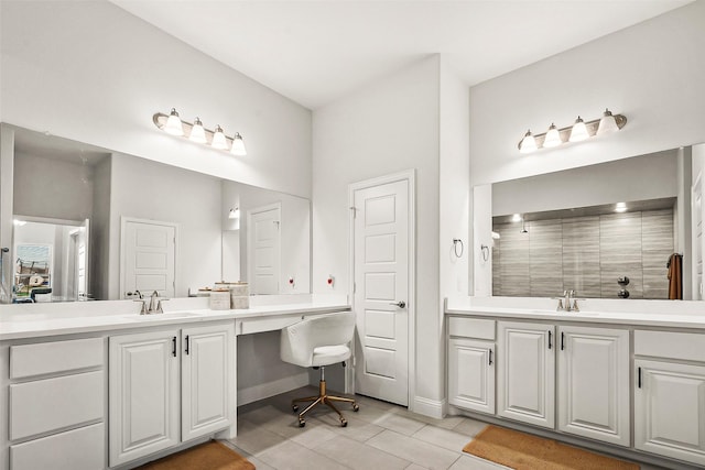 bathroom with tile patterned flooring, vanity, and walk in shower