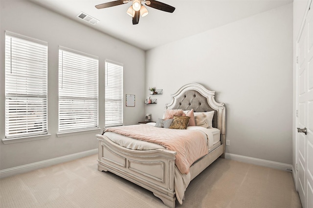 bedroom featuring light carpet and ceiling fan