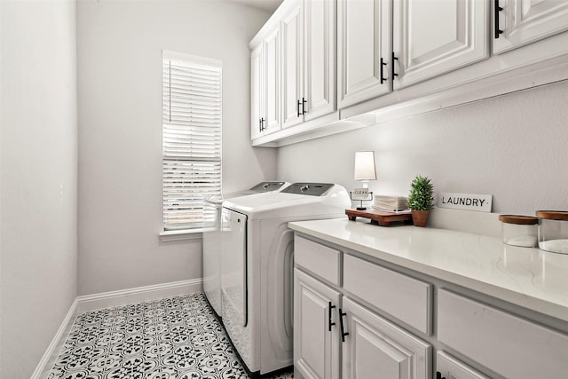 clothes washing area with light tile patterned flooring, cabinets, and independent washer and dryer