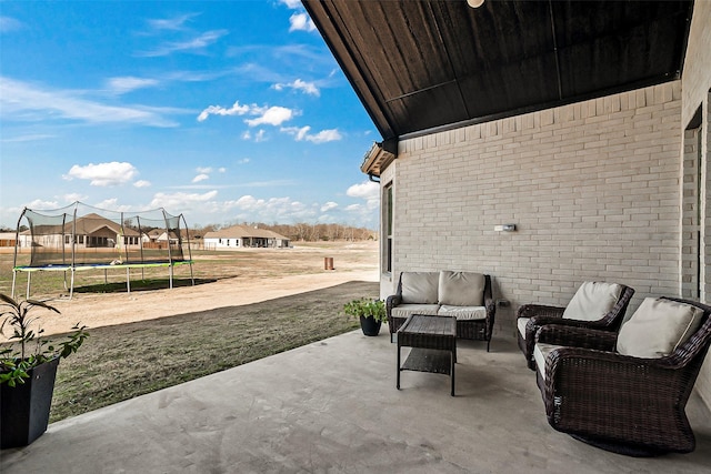 view of patio / terrace with a trampoline and an outdoor hangout area