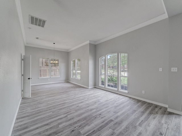 interior space featuring visible vents, baseboards, and wood finished floors