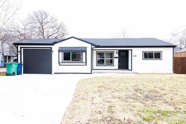 ranch-style home with a front yard and a garage