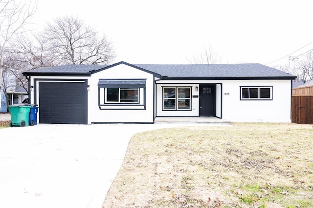 single story home featuring a garage and a front yard