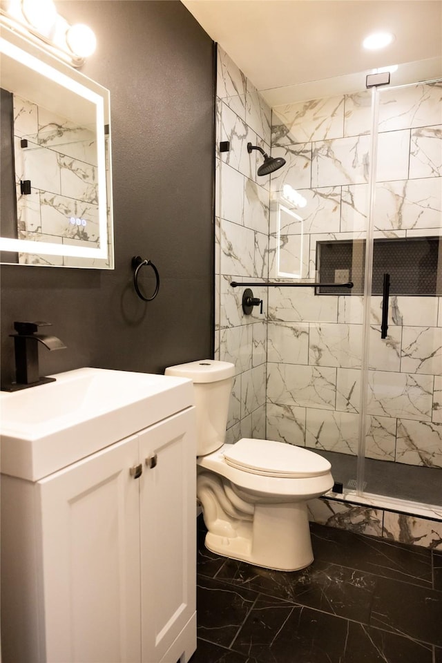 bathroom with walk in shower, vanity, and toilet