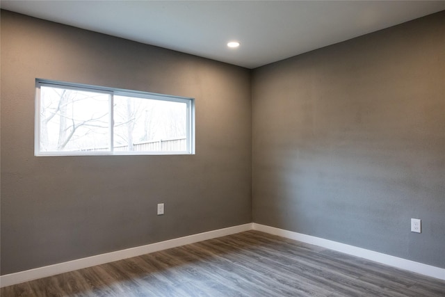 empty room with hardwood / wood-style flooring