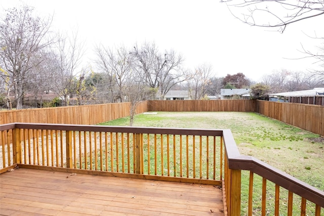 wooden deck featuring a lawn