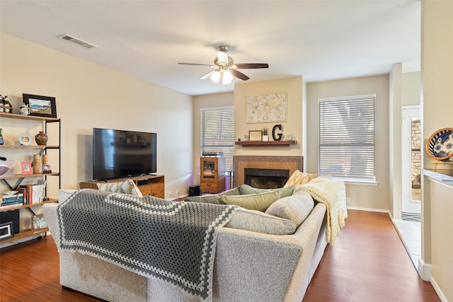 living room featuring hardwood / wood-style flooring and ceiling fan