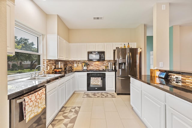 kitchen with white cabinets, sink, backsplash, and black appliances