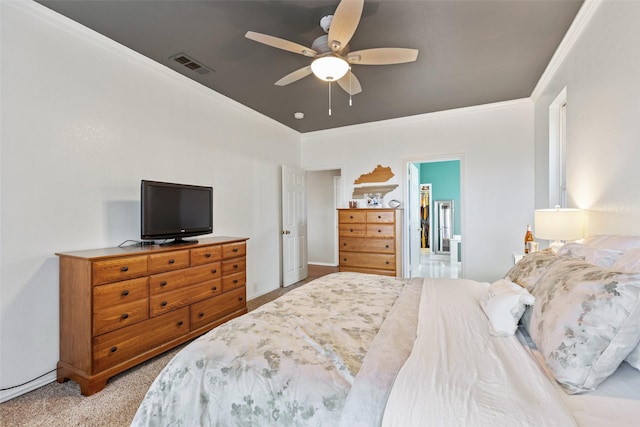 carpeted bedroom with ceiling fan, crown molding, and ensuite bath