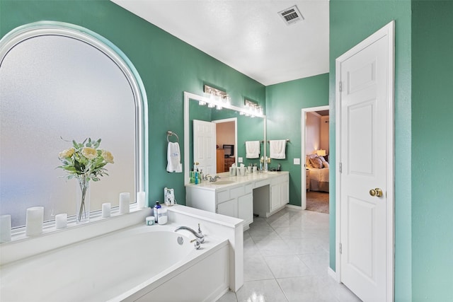 bathroom featuring a bathing tub, tile patterned flooring, and vanity