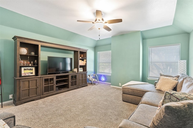 carpeted living room with vaulted ceiling and ceiling fan