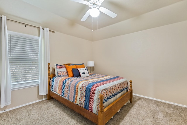 carpeted bedroom with ceiling fan and lofted ceiling