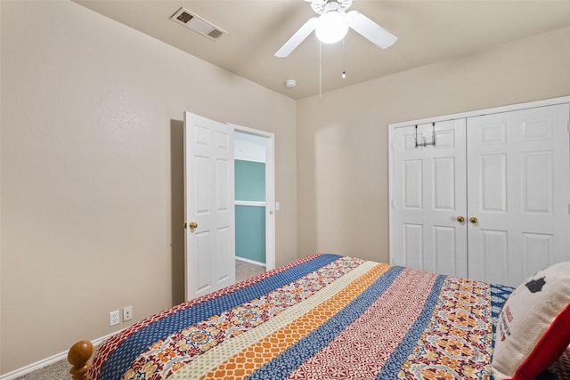 carpeted bedroom with ceiling fan and a closet