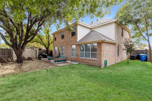 rear view of house with central AC unit, outdoor lounge area, a yard, and a patio