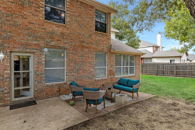 back of property with a lawn, a patio area, and an outdoor living space