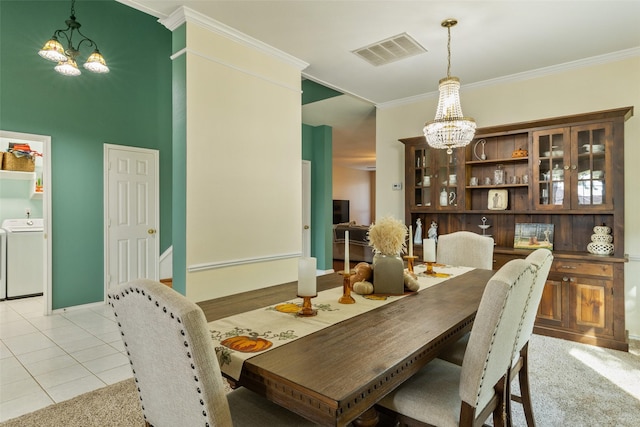 dining area featuring light tile patterned flooring, ornamental molding, and an inviting chandelier